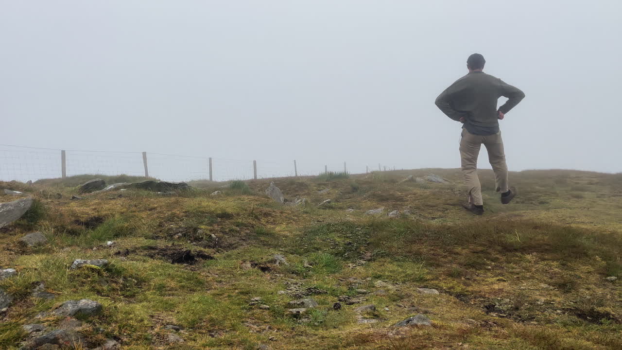 A man dancing on the hill of conor pass Ireland