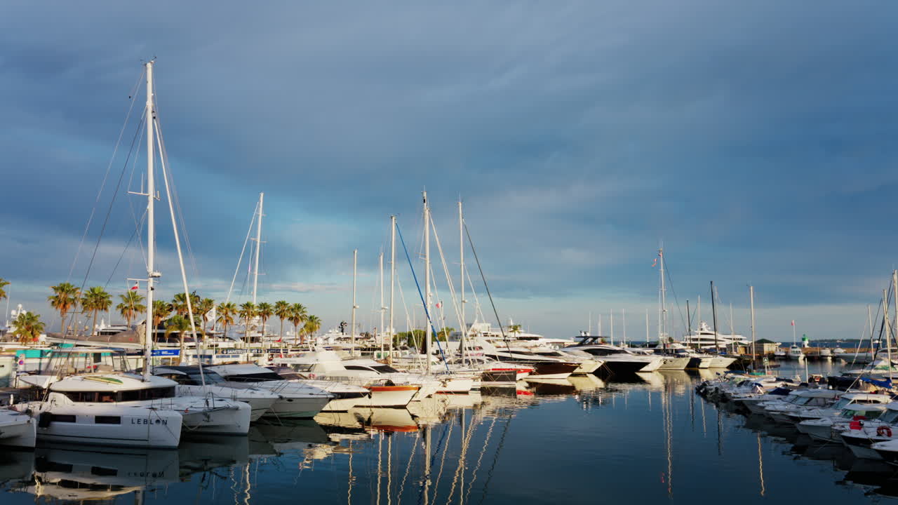 Antibes, France - May 23, 2025: Multiple white boats docked in the Port Vauban on a cloudy day