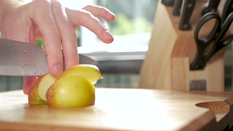 slow motion of an apple being cut up into bite-sized pieces