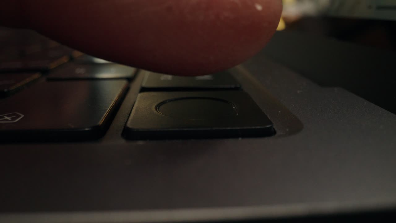 Finger on laptop keyboard button