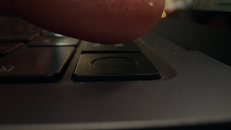 finger on laptop keyboard button