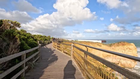 people walking along a coastal boardwalk