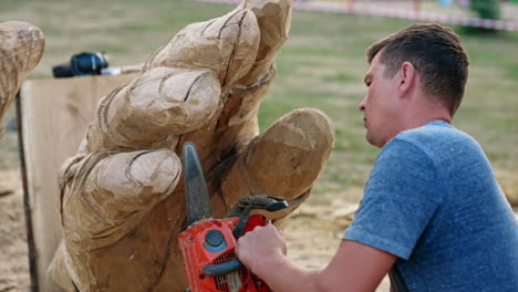 chainsaw carving of a giant hand