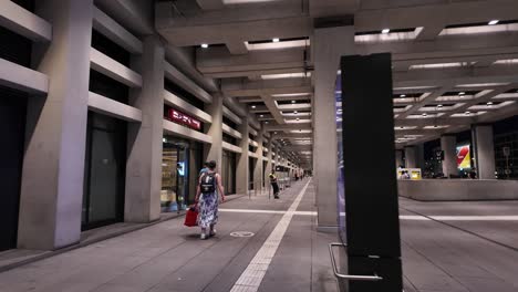 a view of a spacious airport corridor with travelers walking at berlin brandenburg airport. the scene captures a modern architectural atmosphere with an urban feel.