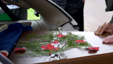 closeup shot of a funeral casket in a hearse or chapel or burial at cemetery