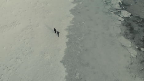 drone shot of people walking in the snow