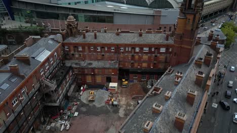 Aerial-drone-flight-over-London-Road-Fire-Station-rooftop-with-a-revealing-shot-of-Piccadilly-Train-Station