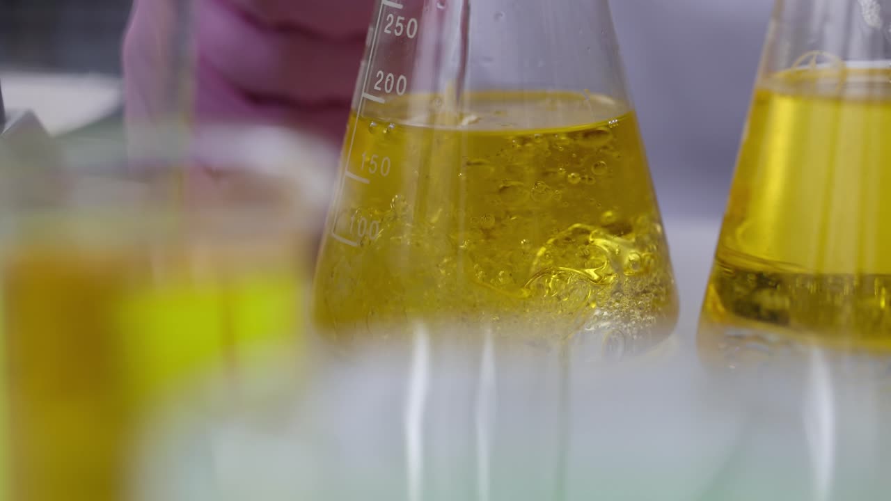 Laboratory Experiment with Yellow Liquid in Beakers