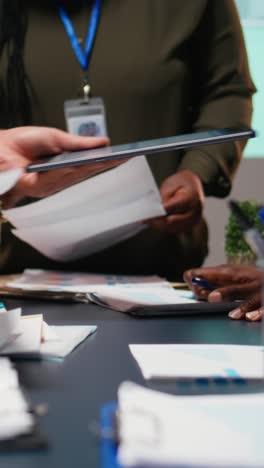 vertical video diverse business team exchanging insights and forecasting diagrams