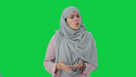 angry muslim businesswoman shouting on someone green screen