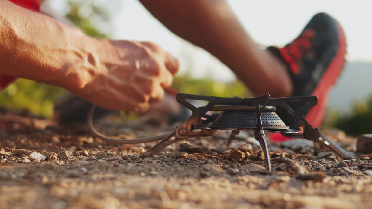 Preparing a meal outdoors with a portable stove