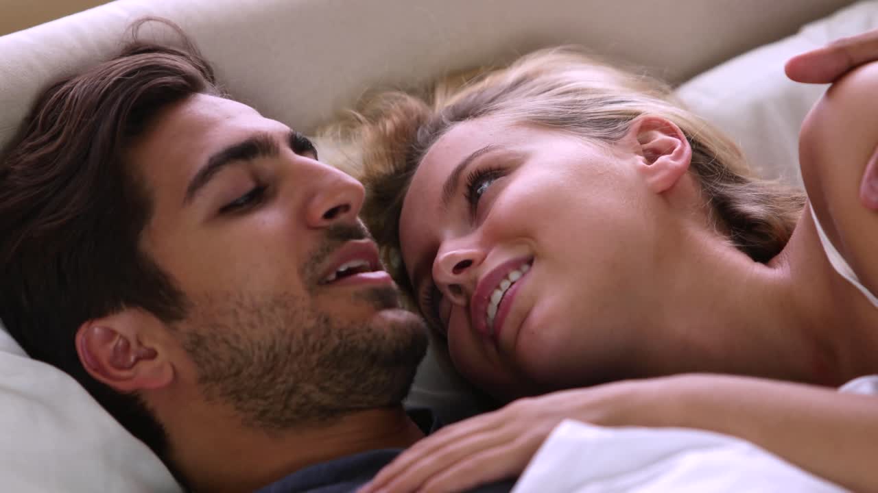 Cute couple speaking in bed