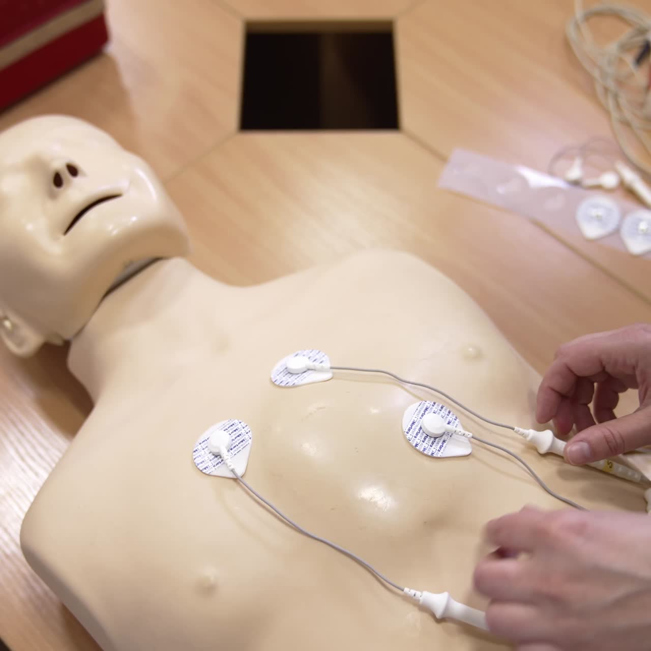 CPR training medical procedure. Instructor demonstrating CPR on mannequin at first aid training course