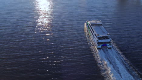 The-San-Francisco-to-Alameda-Ferry-transports-tourists-and-commuters-by-the-Port-of-Oakland---Aerial-tilt-up-reveal