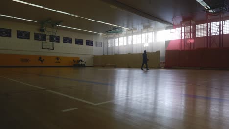 Male-Running-and-Playing-Alone-On-Basketball-Court-In-4K