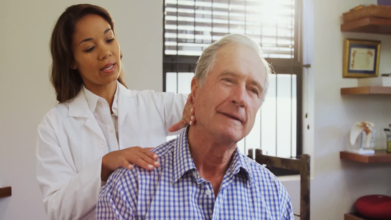 Senior man receiving neck massage from physiotherapist 4k