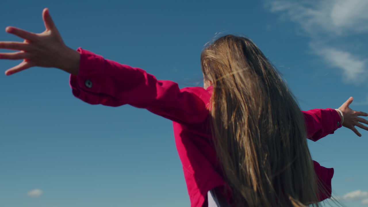 Young Girl Moves Long Hair Young Girl Moves Long Hair on Beautiful Greenery Hill Enjoying Flows of Warm Wind Watching at Amazing Landscape Spending Leisure Time Outdoor back View Slow Motion