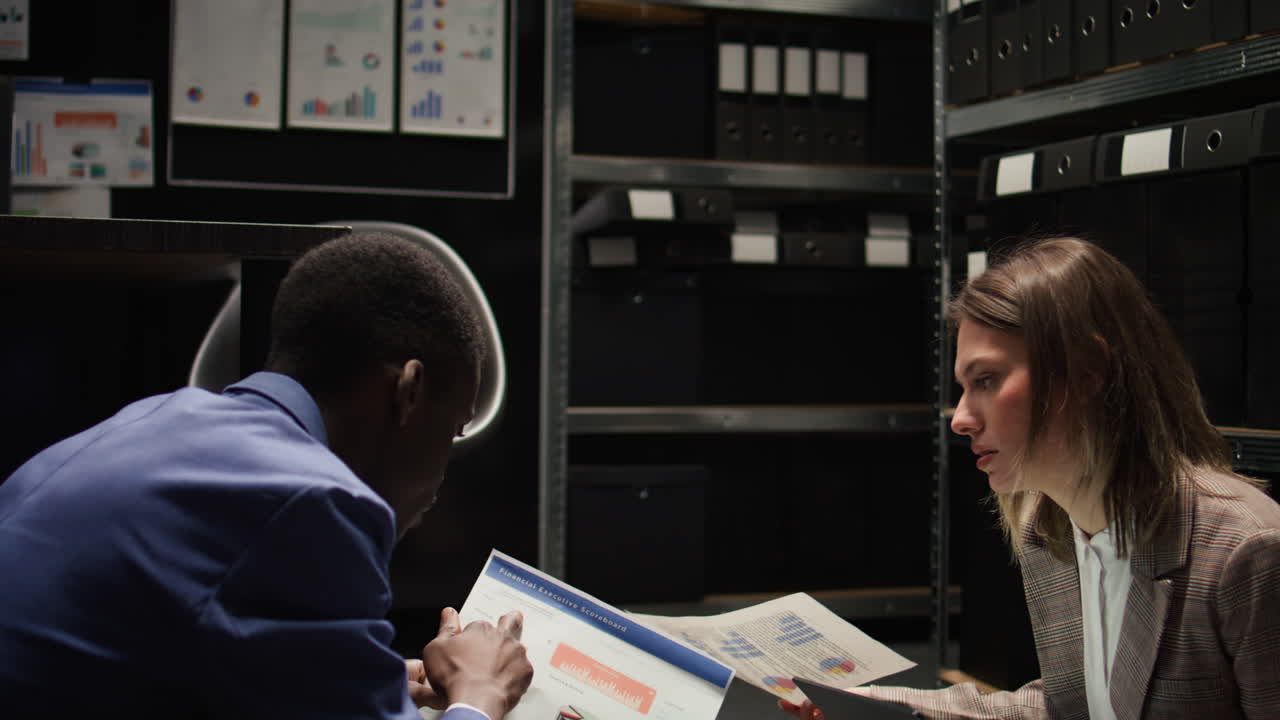 Business Professionals Analyzing Documents in Archive Room