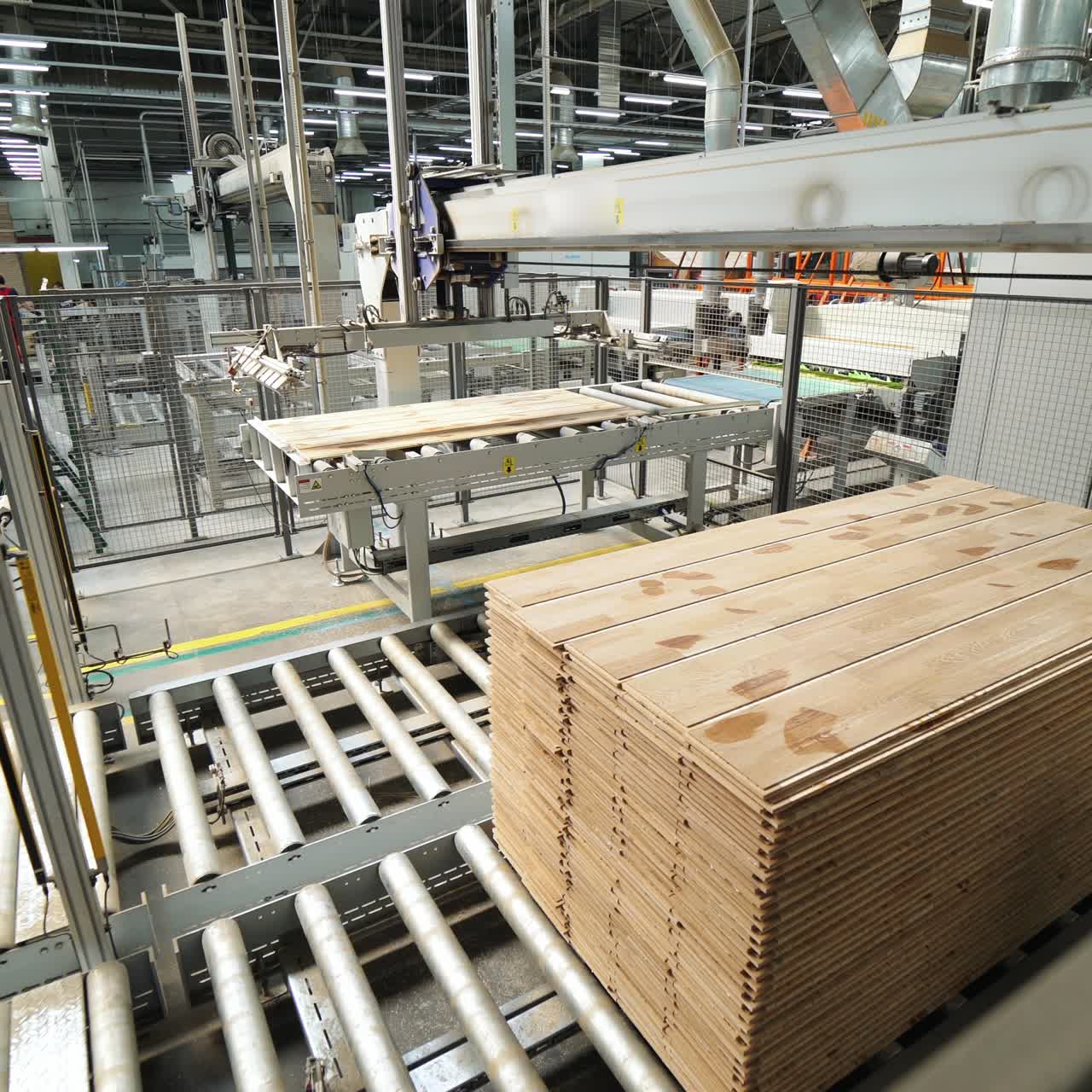 Floorboard production in the industrial factory. Manufacturing of a parquet board. Modern technologies.