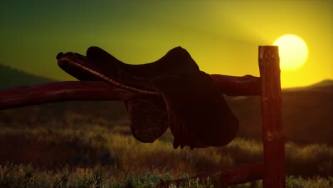 old saddle as the sunset in the country