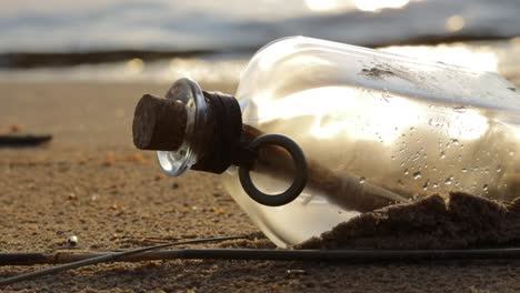 Message-in-the-bottle-against-the-Sun-setting-down