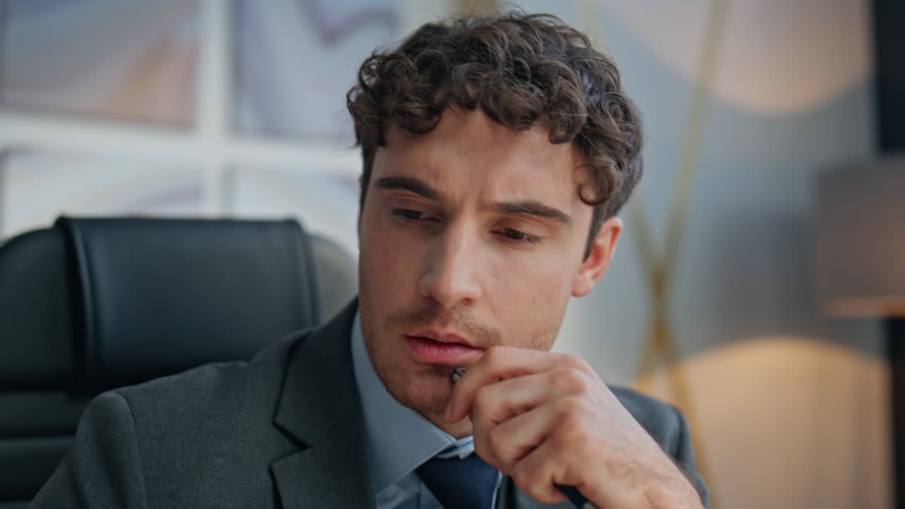 Stressed executive looking solution at workplace closeup. Man checking papers