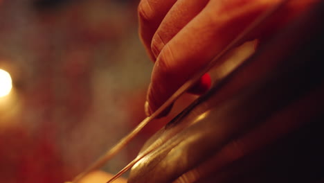 male hand playing contrabass on concert