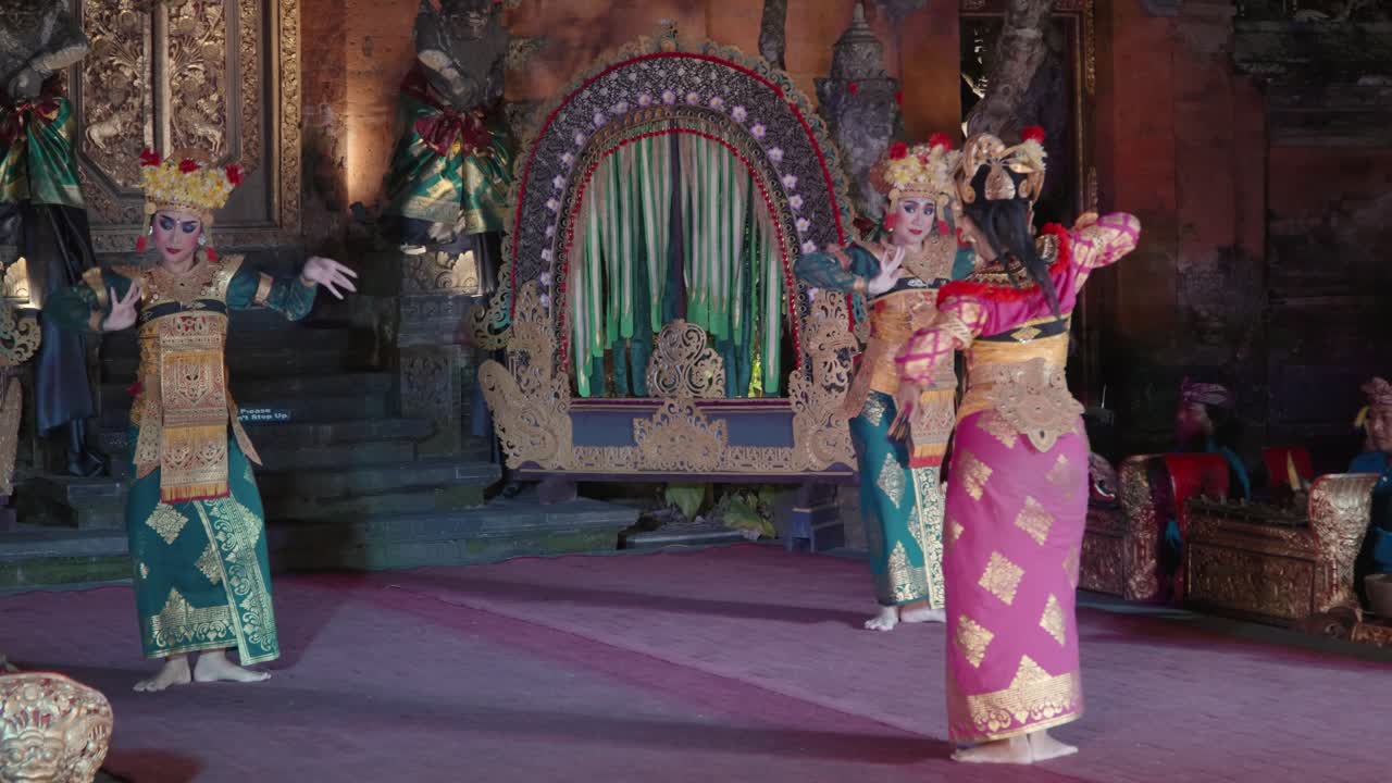 Balinese Legong Traditional Theater Dance Performance at Ubud Palace, Bali - Three Female Dancers in a Court Dancing Together