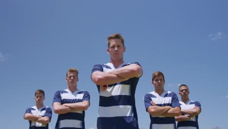 rugby players standing arms crossed