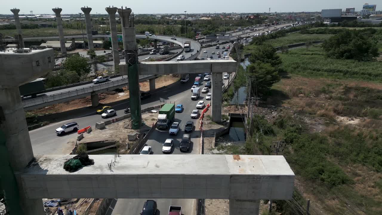 Aerial view of elevated highway construction with ongoing traffic