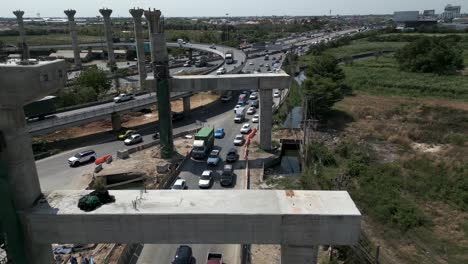 aerial view of elevated highway construction with ongoing traffic