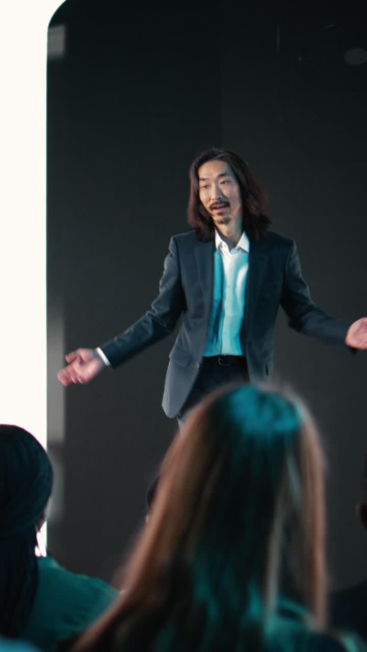 Vertical Video Asian speaker hosting new smartphone launch event showcasing smart display