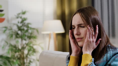 woman massaging her temples