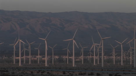 multiple wind turbines turn in the california desert