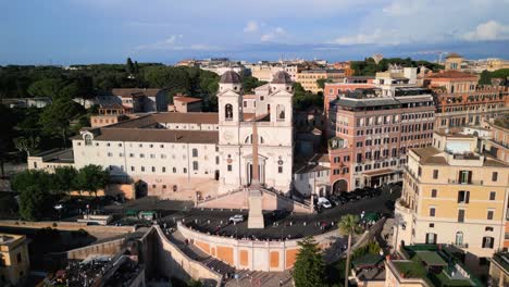 Drone-Descends-to-Reveal-Trinita-dei-Monti-Church,-Beautiful-Spanish-Steps