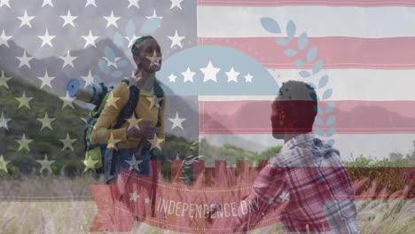 animation of independence day text over smiling diverse couple high fiving and hiking