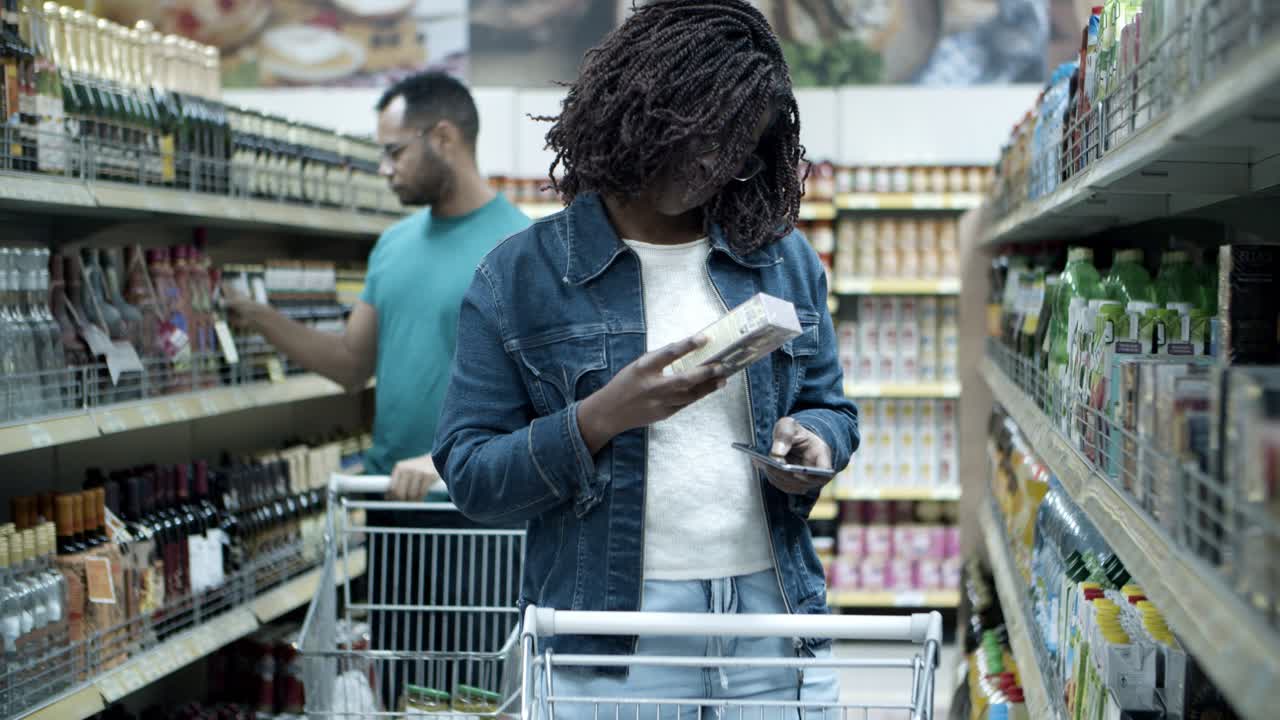Serious customers choosing goods in aisle