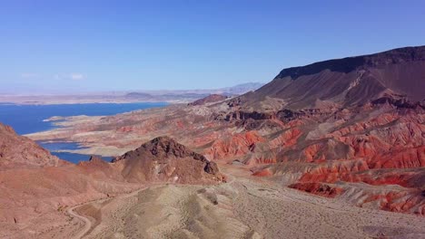 aerial view overlooking kingman wash desert and rocky mountains with lake mead in the background in sunny, usa - pan, drone shot