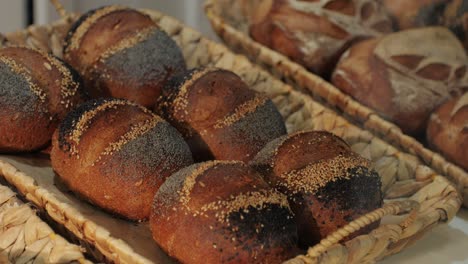 fresh artesian bread on bakery shop close-up. bread with black poppy garnish on top and white flour on top. artisan bread is making by skill bakers using natural and high-quality ingredients. food with health and flavour benefits.