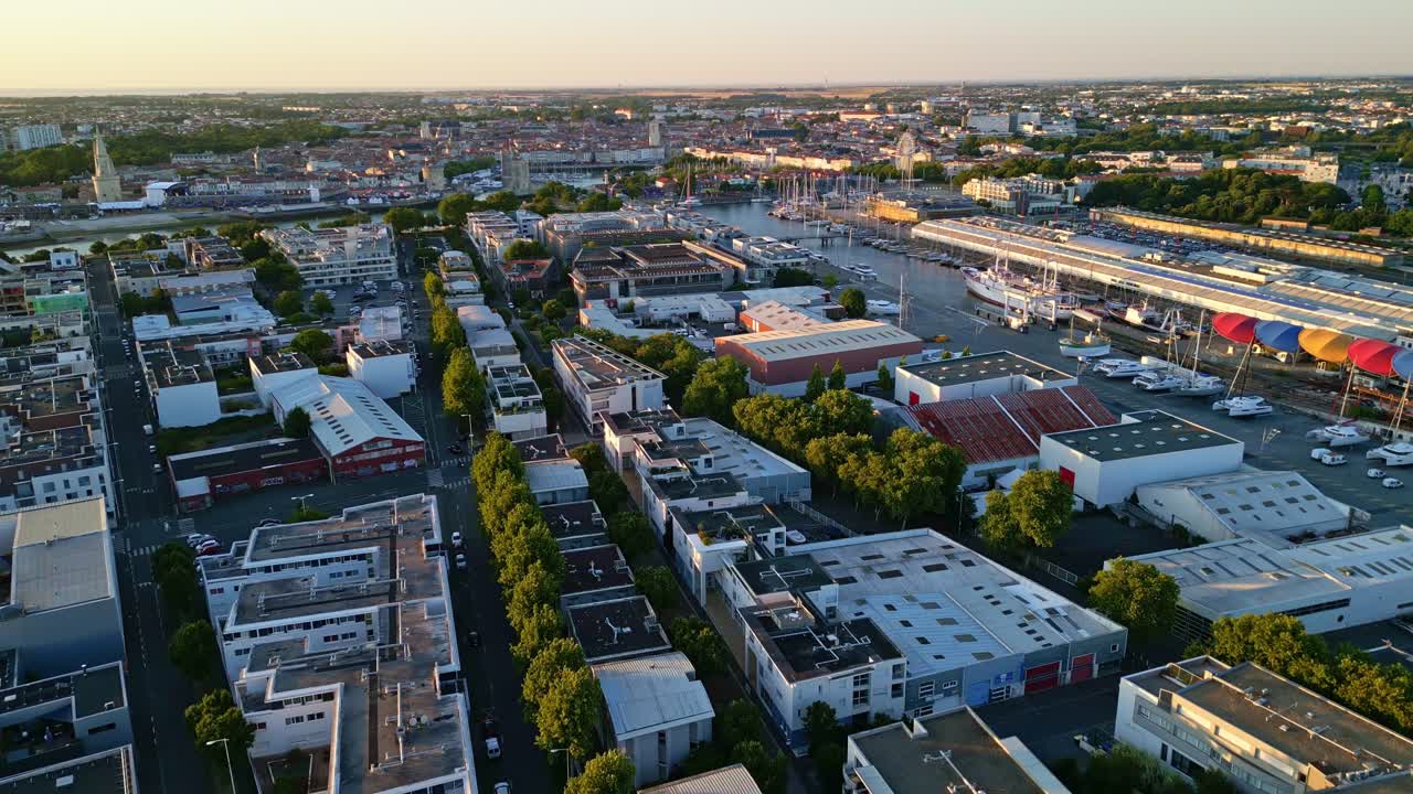 La Rochelle port and cityscape at sunset, France. Aerial backward
