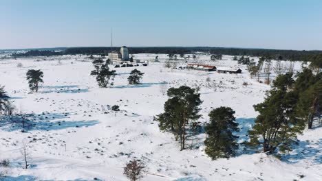 farm covered in snow, aerial view