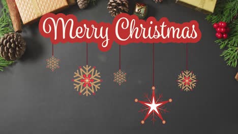 Merry-christmas-text-banner-against-multiple-christmas-decorative-items-on-red-surface