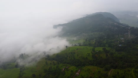 mountains and rural terrain covered with heavy fog clouds in nepal