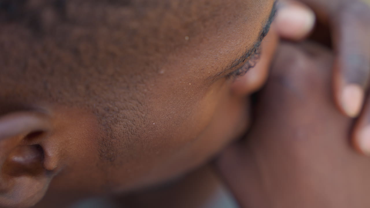 Black man closeup anxious hands near mouth, tight profile, skin detail, tension in jaw, focused gaze, exam prep mood, raw candid emotion, cinematic shallow depth for mental health storytelling