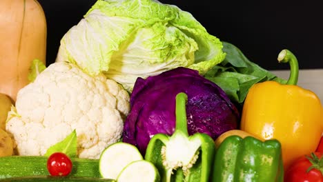 assorted vegetables arranged against a black background