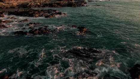 Vuelo-De-Paralaje-De-Drones-Sobre-Rompiendo-El-Oleaje-En-La-Playa-Rocosa-De-Costa-Rica-Al-Atardecer