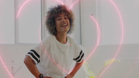 smiling woman with hands on hips over pink heart animation