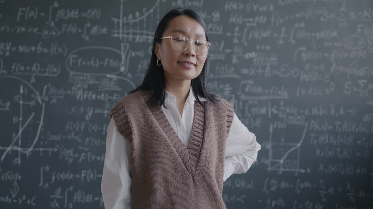Portrait of a Teacher in Front of a Blackboard Filled with Math Equations