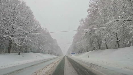 car road trip cruising through the idyllic snow covered countryside and woods