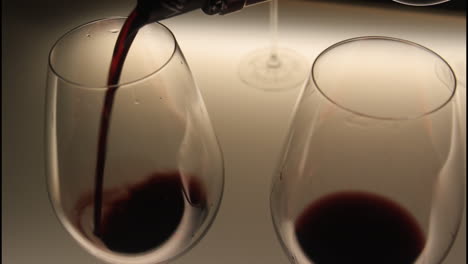 wine being poured into wine glasses